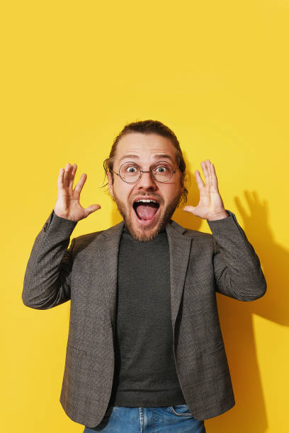 istock Amazed man with an exaggeratedly large head against yellow background 1772889570