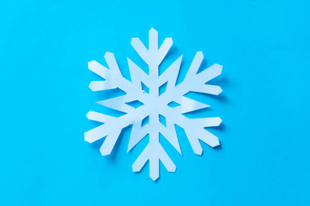 istock snowflake paper cut on blue background 1772889580