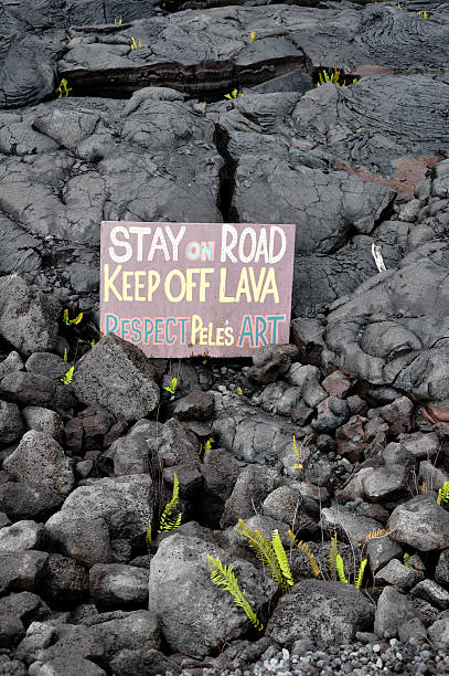 Sign In The Lava A sign warns visitors to stay away from the lava flow on the Big Island of Hawaii. pele stock pictures, royalty-free photos & images