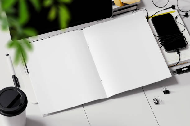 istock Opened stitched booklet on the workplace mockup. 3D rendering 1772899866