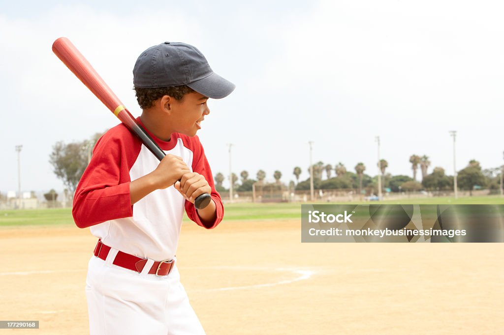 Little boy in baseball uniform practicing his swing Young Boy Playing Baseball In Park Baseball - Ball Stock Photo