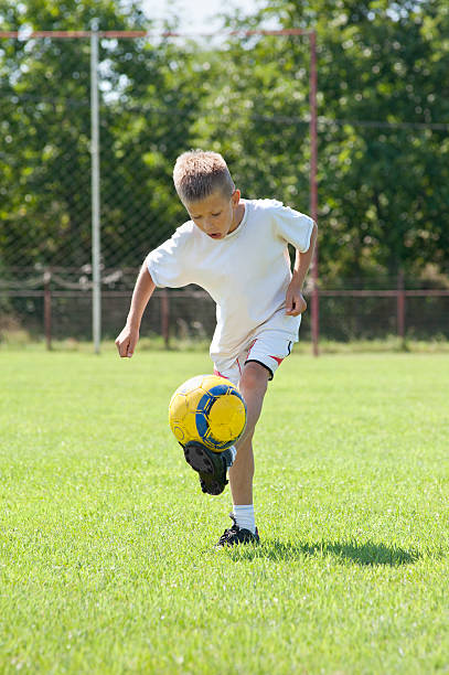 istock Child playing soccer ball 177290198