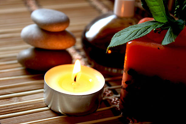 istock spa candle, massage stones and oils 177290574