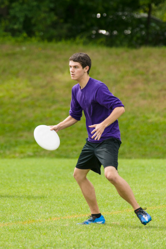 A male playing ultimate frisbee