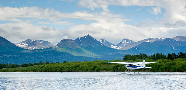 Float Plane Taxis for Take off Airport Lake in Alaska Alaska Float Plane still on the water chugach mountains photos stock pictures, royalty-free photos & images
