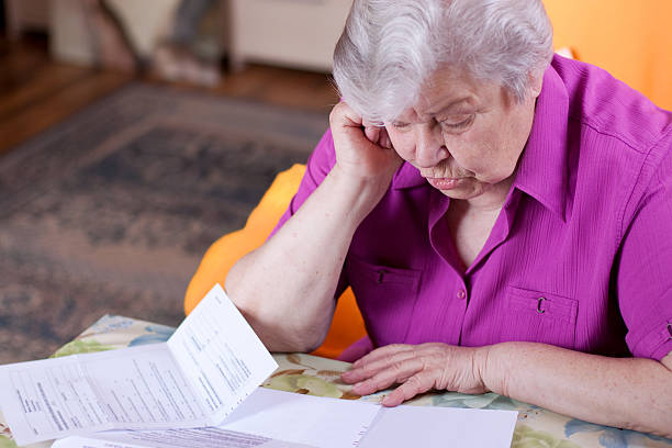 istock Senior reads papers and works hard 177292331