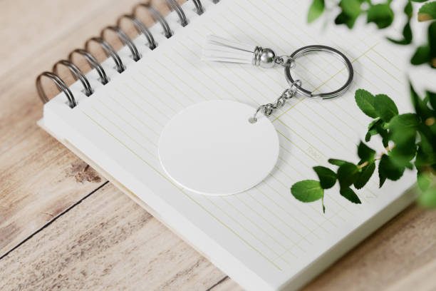 istock Round shape keychain with tassel on spiral notebook mockup. 3D rendering 1772932089