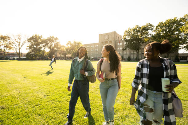 istock Female friends walking on university campus lawn 1772935278