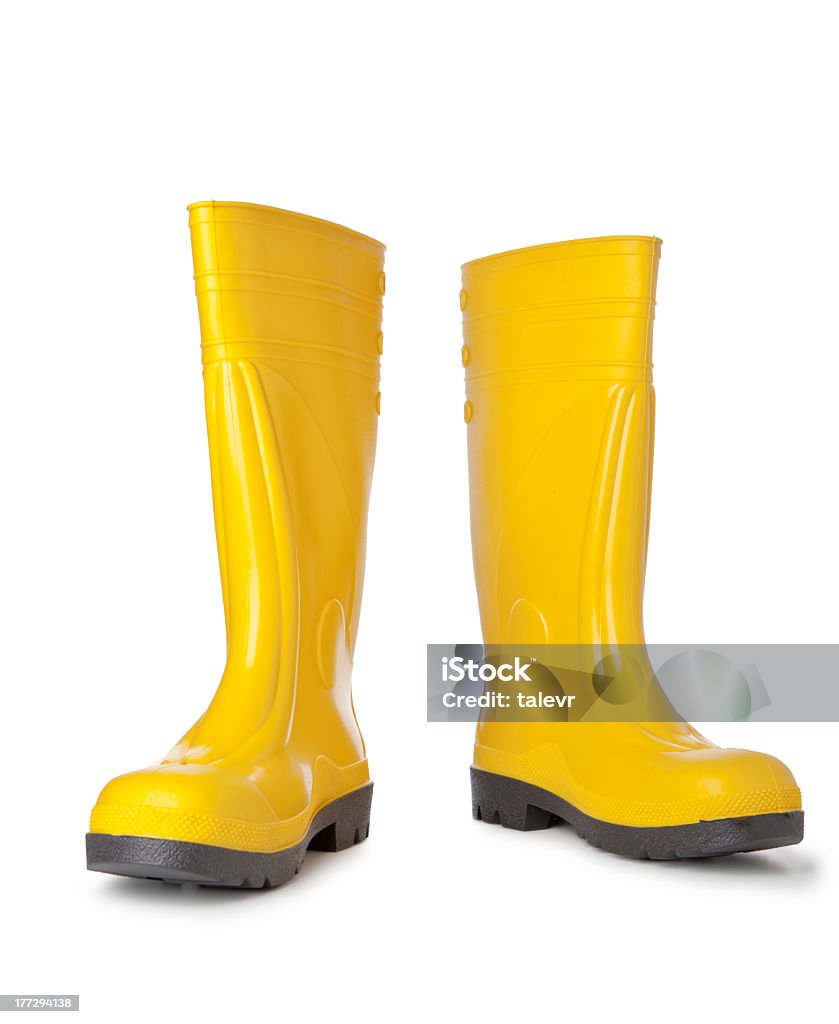 A pair of bright yellow rain boots on white background Yellow rubber boots isolated on white background Rubber Boot Stock Photo