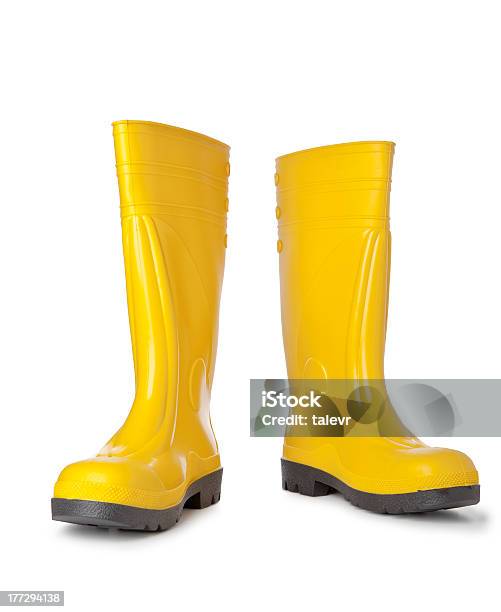 A Pair Of Bright Yellow Rain Boots On White Background Stock Photo - Download Image Now