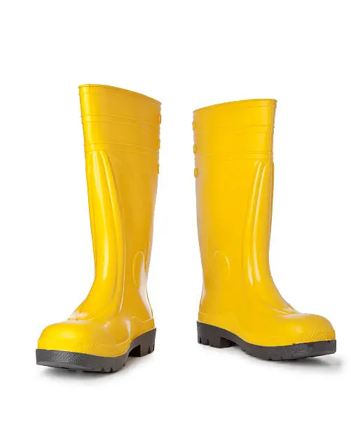 Photo of A pair of bright yellow rain boots on white background