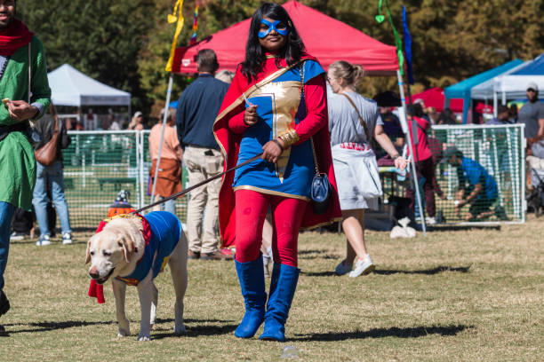 woman and dog wear superhero costumes at atlanta halloween contest - superman superhero heroes cape imagens e fotografias de stock