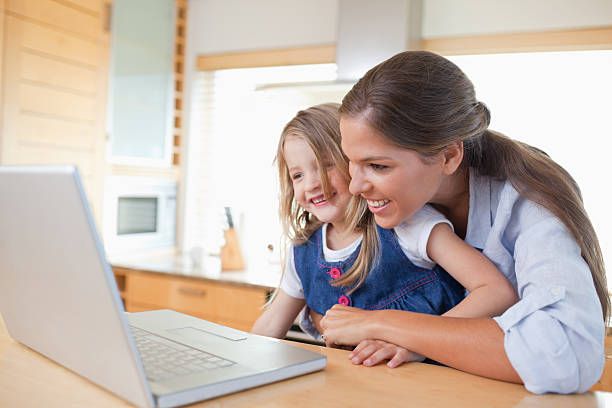 istock Smiling mother and her daughter using a laptop 177294529