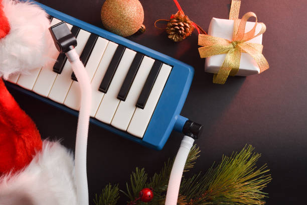istock Melodica as a Christmas gift on black table with decoration 1772964534