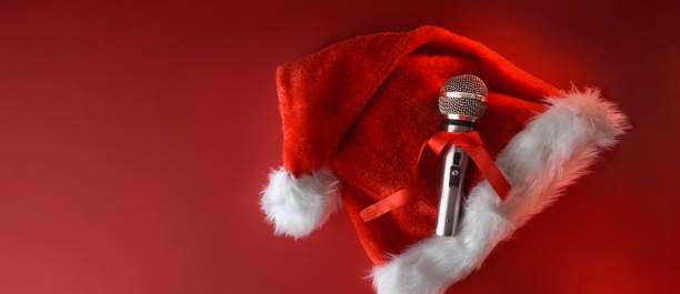 istock Metal microphone on santa hat isolated on red background 1772964551