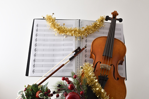 Old violin and fir-tree branches with Christmas decor. Christmas, New Year's concept. Top view, close-up