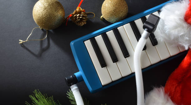 istock Melodica on black table with Santa hat and Christmas decoration 1772965086