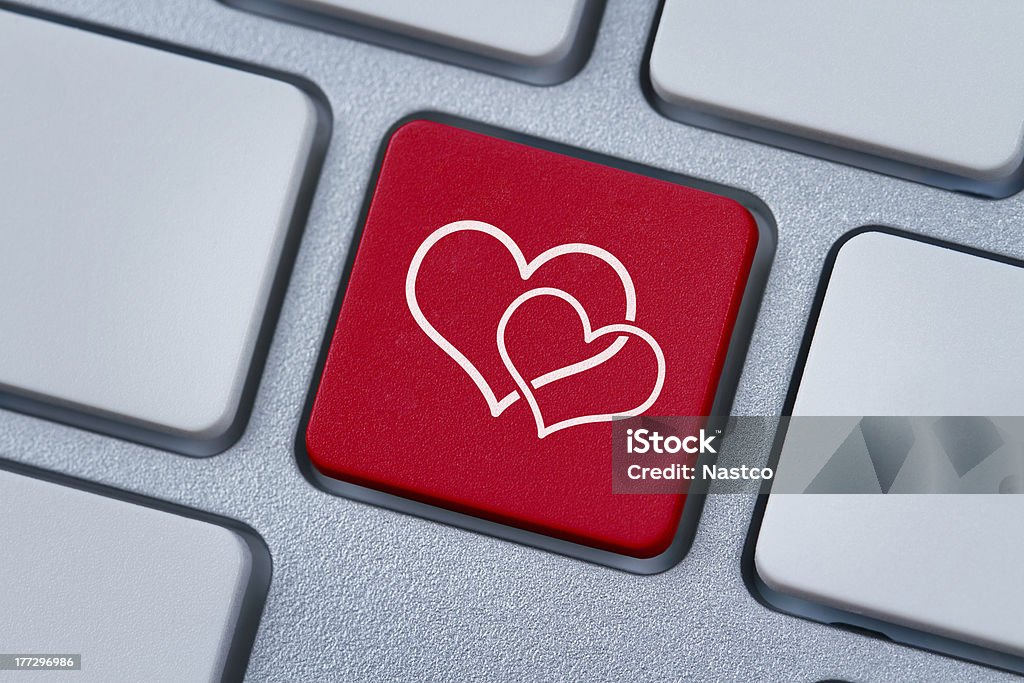 Online love key Two hearts symbol at the red computer key Internet Stock Photo