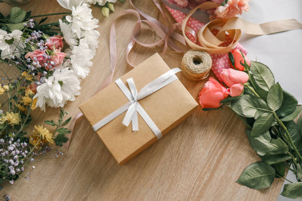 istock Gift box in hands with flowers at home 1772977067