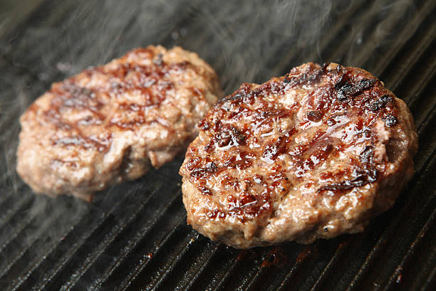 Beef Burgers Cooking on Griddle