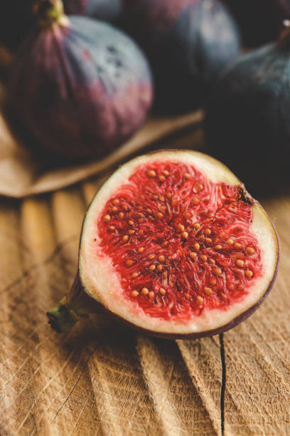 istock A few figs in a bowl on an old wooden background. 1772986483