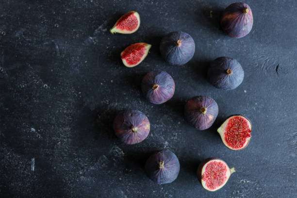 istock fresh ripe figs on dark background, top view 1772986486