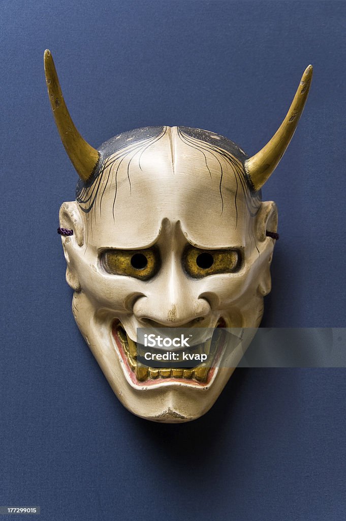 Japanese Traditional Face Mask,Nohmask Hannya The Hannya mask with its horns and sharp fangs is probably the best known of all Noh masks. The mask expresses the fury of a woman turned demon through jealousy and anger and who revenges by attacking. Hannya Mask Stock Photo