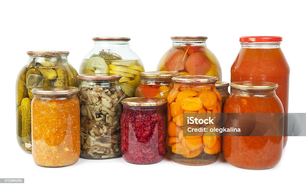 Food Collection of many glass bottles with preserved food on white background Apricot Stock Photo