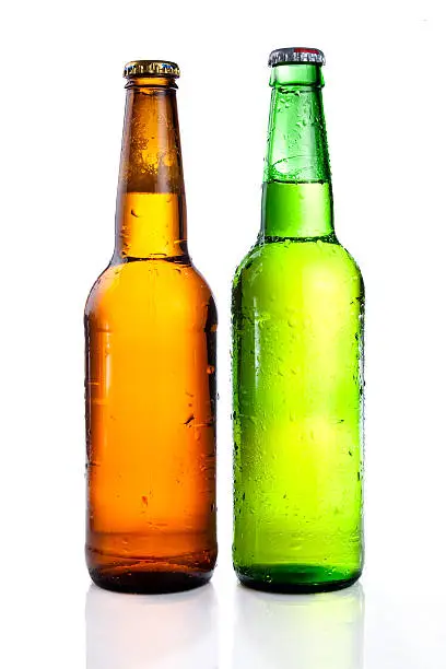 Photo of Green and brown beer bottle with drops drink without label