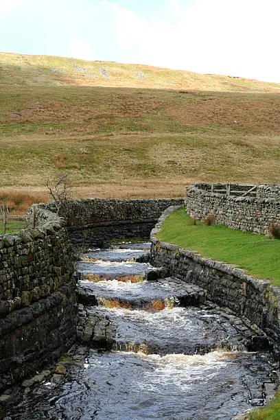 Force gill is channelled along a race as part of the construction of the Settle to Carlisle railway high on Blea Moor in the Pennines of Yorkshire.