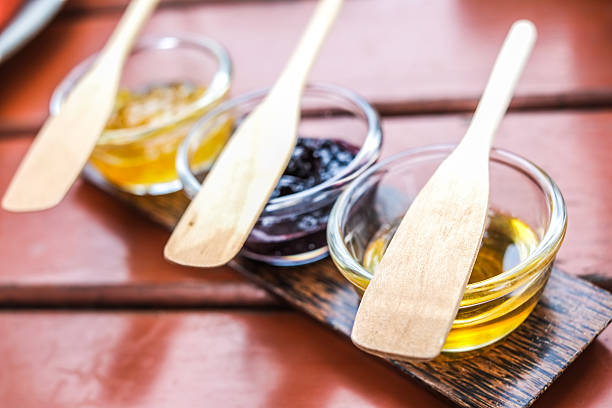 Sweet quince jam in glass dish with wood spoon stock photo