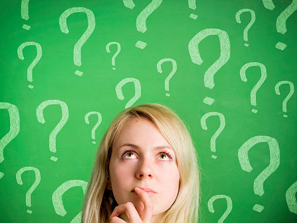 istock Thinking woman in front of blackboard with question marks 177299859