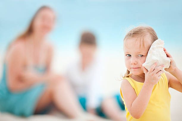 istock Little girl with seashell 177300455