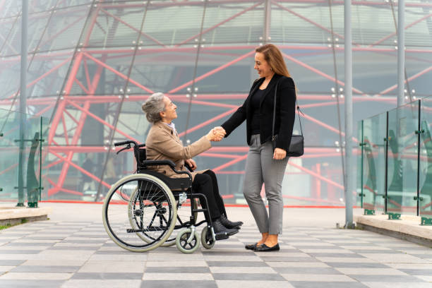 Two Female Employees, Agreeing on a Business Issue, Shake Hands with Happiness and Pride