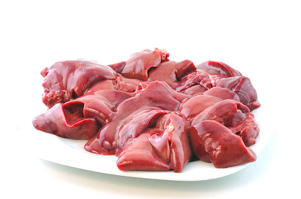 Raw chicken livers Fresh raw chicken liver lies on the plate against a white background animal liver stock pictures, royalty-free photos & images