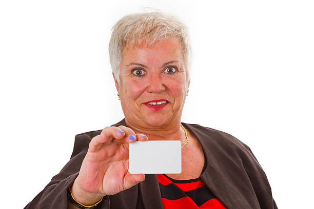 istock Female senior with business card 177300852