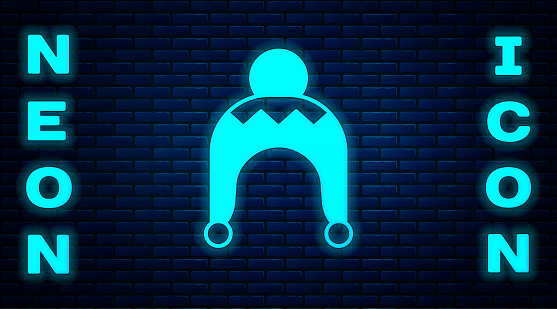 Glowing neon Winter hat icon isolated on brick wall background. Vector.