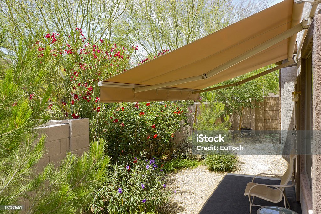 Awning Retracted over Doorway Arizona backyard with automatic retractable awning for extra shade Awning Stock Photo