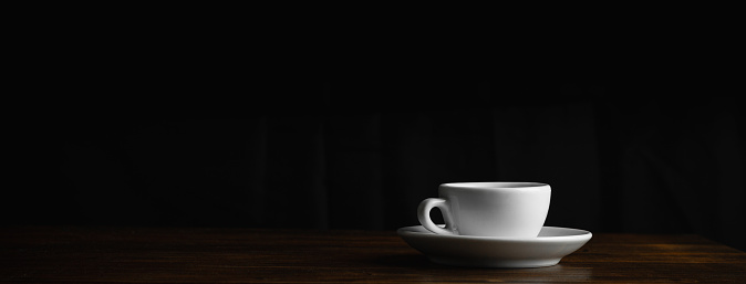 Coffee cup on dark background. Copy space