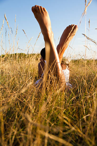 feet in grass feet of young woman in grass beines stock pictures, royalty-free photos & images