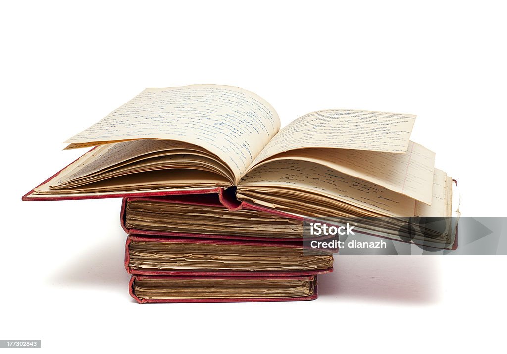 stack of old books with red covers and open one stack of old books with red covers and one of them open on top Antique Stock Photo