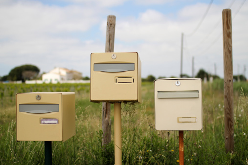 Gele Duitse postbox één in de groene weide in dorp