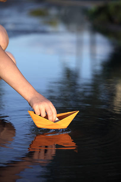 istock paper ship in children hand 177303910