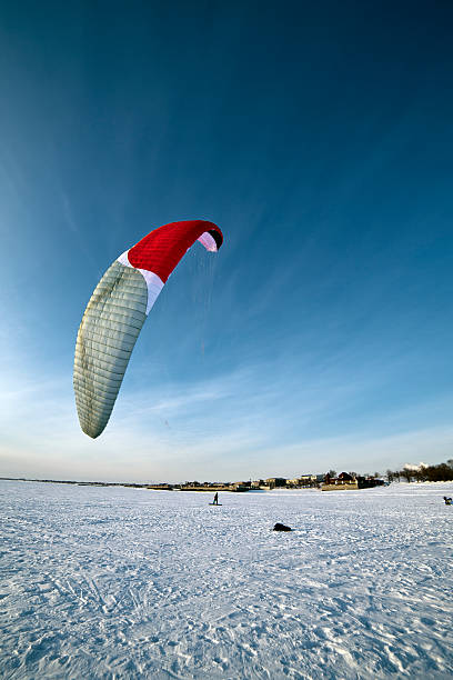 A paragliding over a snow meadow in Czech Republic