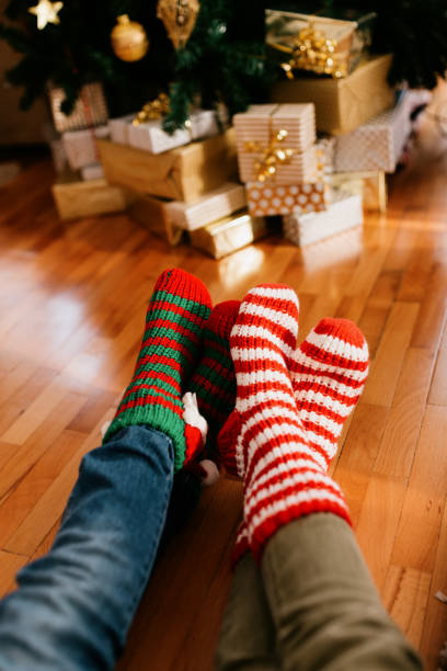 istock Feets with Christmas socks relaxing by the Christmas tree 1773049043