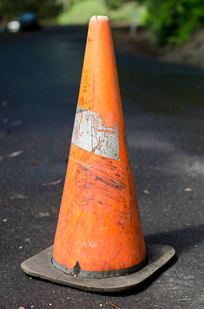 istock Old grungy worn out traffic cone on tarred road 177305289