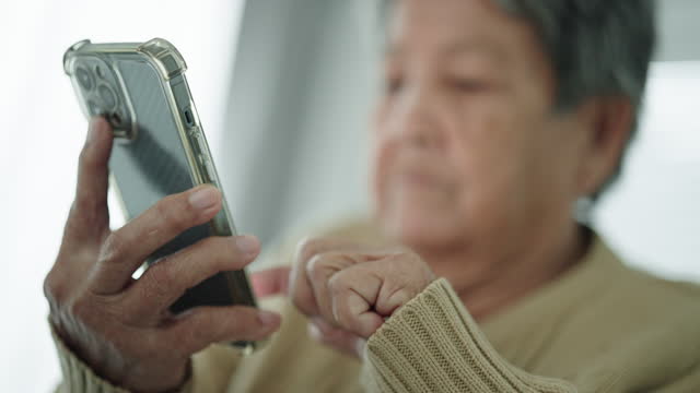 Senior woman using smartphone.