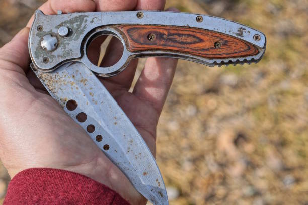 istock one old gray brown rusty folding knife lies on the palm 1773054414