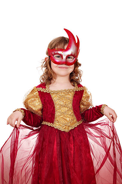 A little girl plays dress-ups as a super hero. 