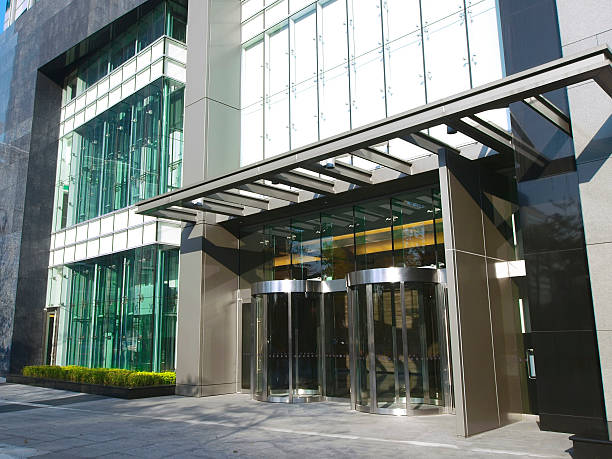 istock 2 revolving glass doors in glass fronted modern building 177305829